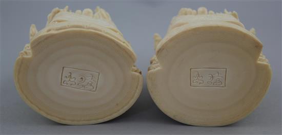 A pair of Chinese ivory seated figures of an emperor and empress, first half 20th century, 13.5cm excl. the wood stands